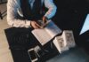 A man dressed in a suit counting money. Depiction of the benefits of languages interpretor