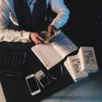 A man dressed in a suit counting money. Depiction of the benefits of languages interpretor