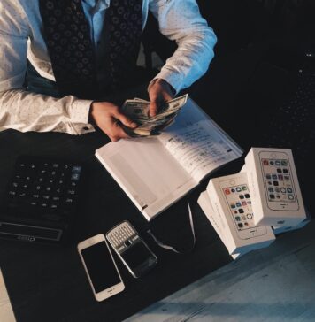 A man dressed in a suit counting money. Depiction of the benefits of languages interpretor