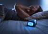 Dealing with Insomnia. Insomniac man lying in bed late in the night.