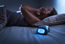 Beat Insomnia Once and For All With These Proven Strategies – 2025 Guide Dealing with Insomnia. Insomniac man lying in bed late in the night.