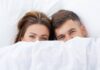 Couple Under Bed Sheets. Guide on How to Have a Better Sex.
