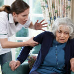 Care Worker Mistreating Senior Woman At Home
