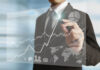 Optimizing Customer Experience: Cost-Efficient Strategies for Outsourcing Support (2025) businessman hand writing business graph