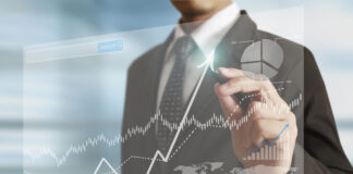 businessman hand writing business graph