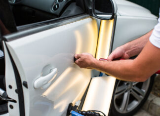 Repairing car dent after the accident by paintless dent repair