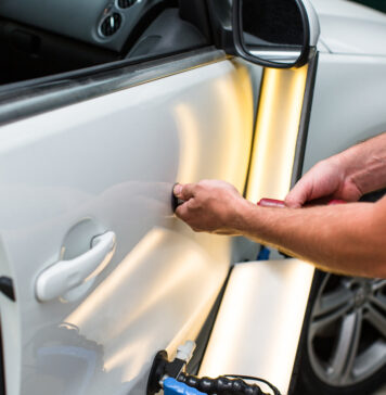 Repairing car dent after the accident by paintless dent repair