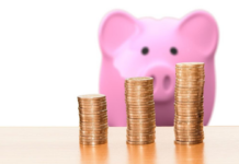 Piggybank with three stacks of coins. Gold Investing Companies representation