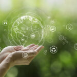 Sustainable development goal (SDGs) concept.Hands holding Global communication network with Environment icon on a green background.Green technology and Environmental technology.ESG