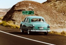 Should You Trade in Your Vintage Car or Sell It Privately? 2025 Guide Teal Vintage Car on the road