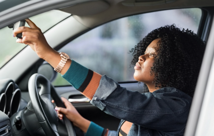 African American Woman in a Car. Article about Car Insurance.