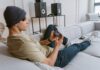 Top Reasons Why Your Business Needs a Mobile Game (2025) Young person on the phone playing a mobile game