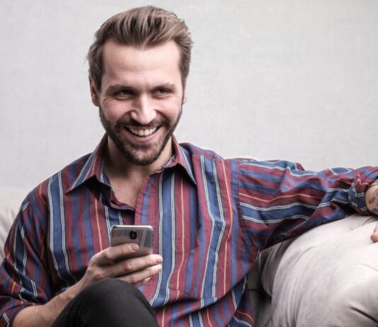 person looking at phone for Online Casino
